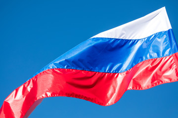 The government flag of Russia on the sky background.