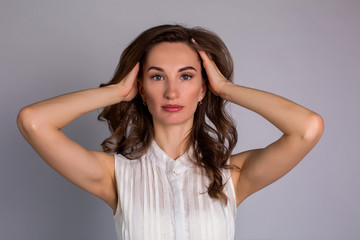 Fototapeta premium young woman makes herself a massage complex of exercises