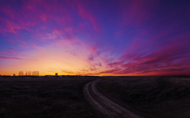 Sunset over the field colorfull with road to future