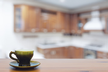 green cup on wooden table