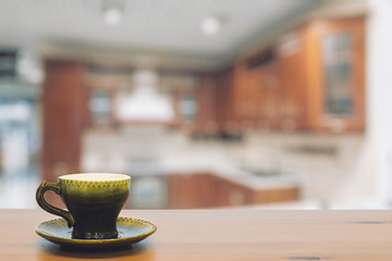 green cup on wooden table