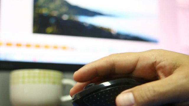 Man  clicking  computer  mouse  with monitor screen