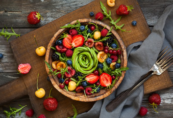 Fototapeta na wymiar Fresh salad with fruit,berry and vegetables.