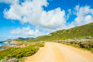 Paragliders over Sardinia coastline in springtime