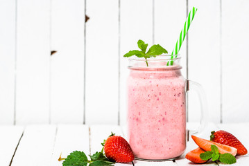 Fruit smoothie with strawberries, milkshake with fresh strawberry blended in jar on white background - obrazy, fototapety, plakaty