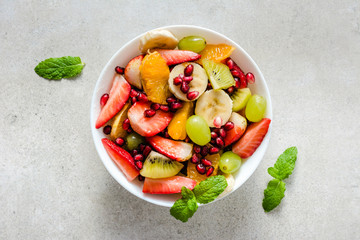 Fresh fruit salad on bright background, healthy diet concept