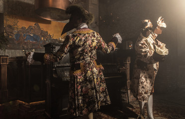 Actors in steam punk masks and antique costumes indoor.