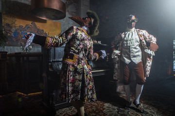 Actors in steam punk masks and antique costumes indoor.