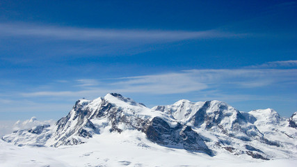 Fototapeta na wymiar panorama mountain landscape in the Swiss Alps near Zermatt on a beautiful day in late winter under a blue sky