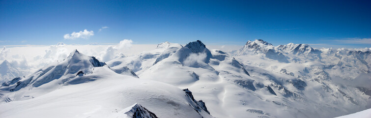 panorama mountain landscape in the Swiss Alps near Zermatt on a beautiful day in late winter under a blue sky