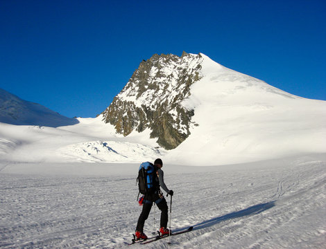 male backcountry skier on his way to the Rimpfischhorn peak in the Alps of Switzerland near Zermatt