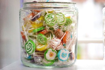 Colorful lollipops in jar    