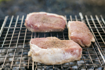 Raw meat on a grill on barbecue
