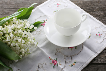 Porcelain cup and bouquet of lily of the valley