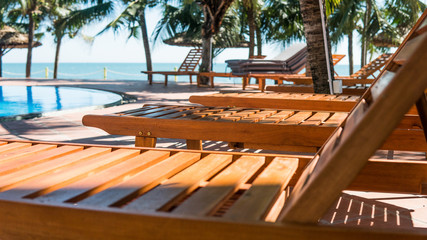 .sun loungers near the hotel swimming pool. Tropical vacation in Asia, millennial concept