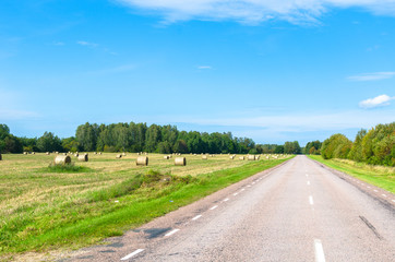 Hay bales by a countryside road in summer. Photo taken in Saaremaa, Estonia