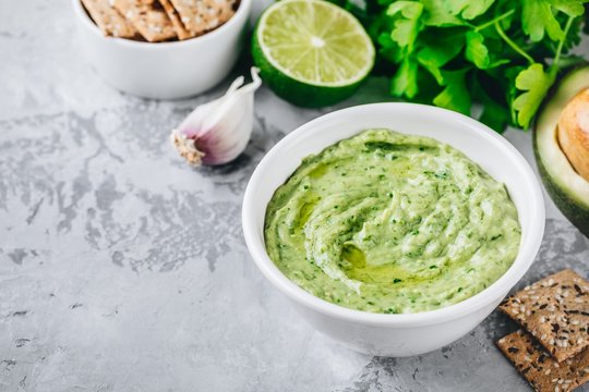 Fototapeta Avocado dip with cilantro and lime