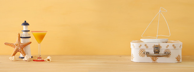 nautical, vacation and travel banner with sea life style objects over wooden table.