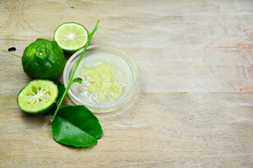 sliced bergamot and green leaf with bergamot meat in translucent dish on wooden table