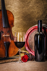 Red wine in glass, barell and violin