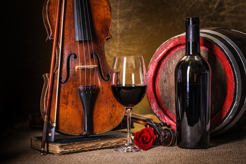 Red wine in glass, barell and violin