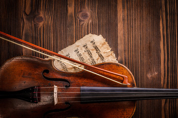 Violin and musical sheets detail with bow