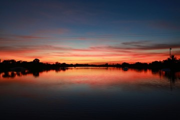 After Sunset on the Ski Rixen Lake with Reddish Orange Clouds at Quiet Waters Park, Deerfield Beach, Florida