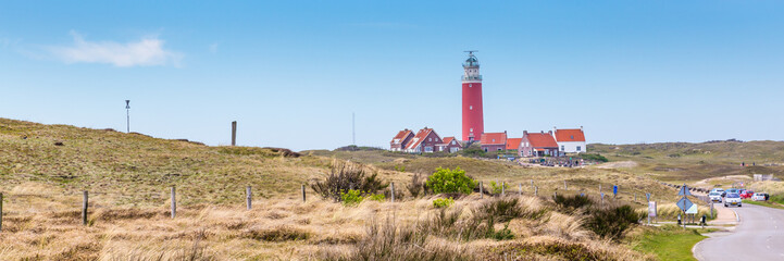 Fototapeta na wymiar Panorama with red lighthouse at wadden island Texel in the Netherlands taken form the sand dunes of teh village Cocksdorp.
