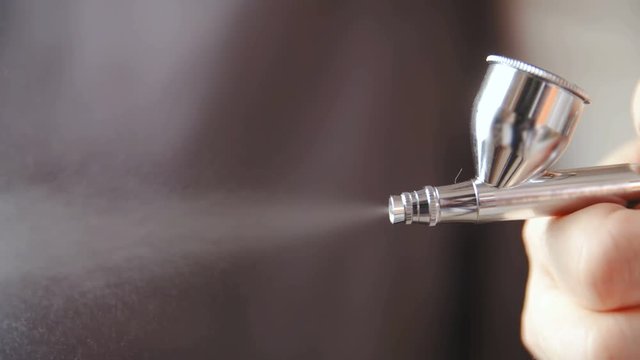 Professional airbrush spray in slow motion 4K