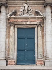Fototapeta na wymiar Entrance portal and statue of the Virgin Mary of the Basilica of Santa Maria in Porto, Ravenna, Italy.