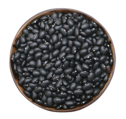 Pile of black beans in wood bowl isolated on white background