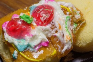 Close up of cake defrmed ugly on wooden table.