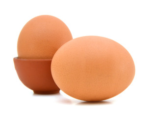 Closeup view of two brown eggs isolated on the white