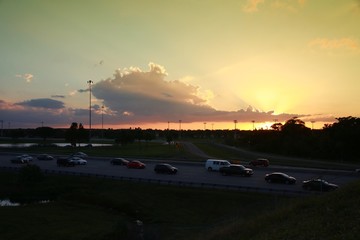 Fototapeta na wymiar Rush Hour Traffic on the Florida Turnpike at the Sample Road Overpass in Pompano Beach at Sunset