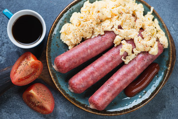 Sausages with scrambled eggs and coffee for breakfast, top view, horizontal shot