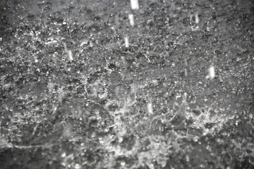 Raindrops Splattering on Pavement During a Torrential Downpour in Florida in June