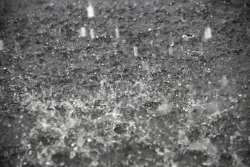 Raindrops Splattering on Pavement During a Torrential Downpour in Florida in June