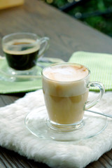 Hot Cappuccino Coffee on wooden table with cozy time.have some space for write wording