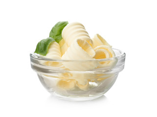 Bowl with tasty butter curls on white background
