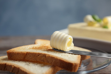 Toasts with tasty butter curl on plate, closeup
