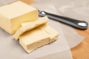 Wooden board with tasty fresh butter, closeup