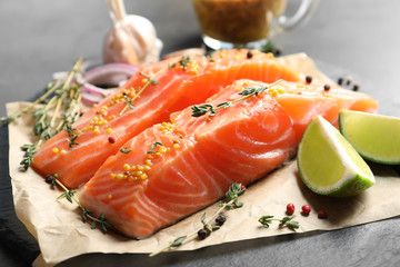 Fresh salmon and ingredients for marinade on slate plate, closeup