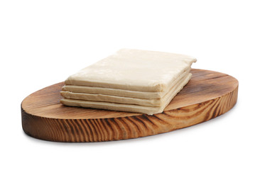 Wooden board with fresh dough on white background. Puff pastry