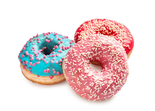 Delicious glazed doughnuts with sprinkles on white background