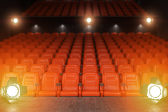 View from the stage of concert hall or theater with red seats and spot light.