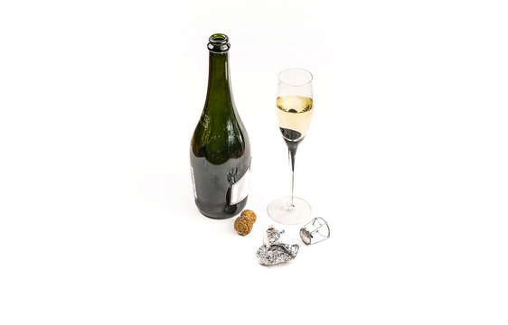 Open bottle and glass with champagne