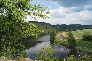 Fototapeta premium panorama to the fields of the river and wooded mountains