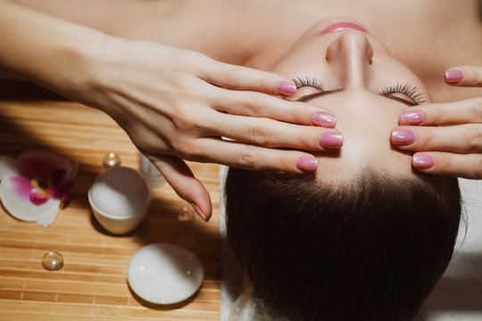 Beautiful natural girl woman in the spa salon, It makes a face massage, facial rejuvenation procedure, spa treatments. Visit a beautician, massage lines. Cosmetology. Massage Toffa. Mesotherapy