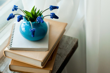  pile of books and spring flowers, the concept of education or reading literature, recreation