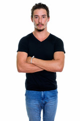 Studio shot of young handsome man standing with arms crossed iso